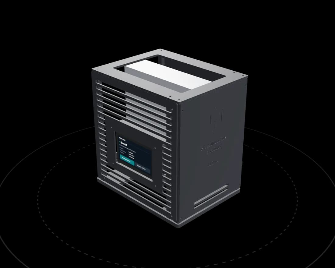 The PK KI-Box: a black enclosure with ventilation slots, a status display on the left side and the PK logo embossed on the front.