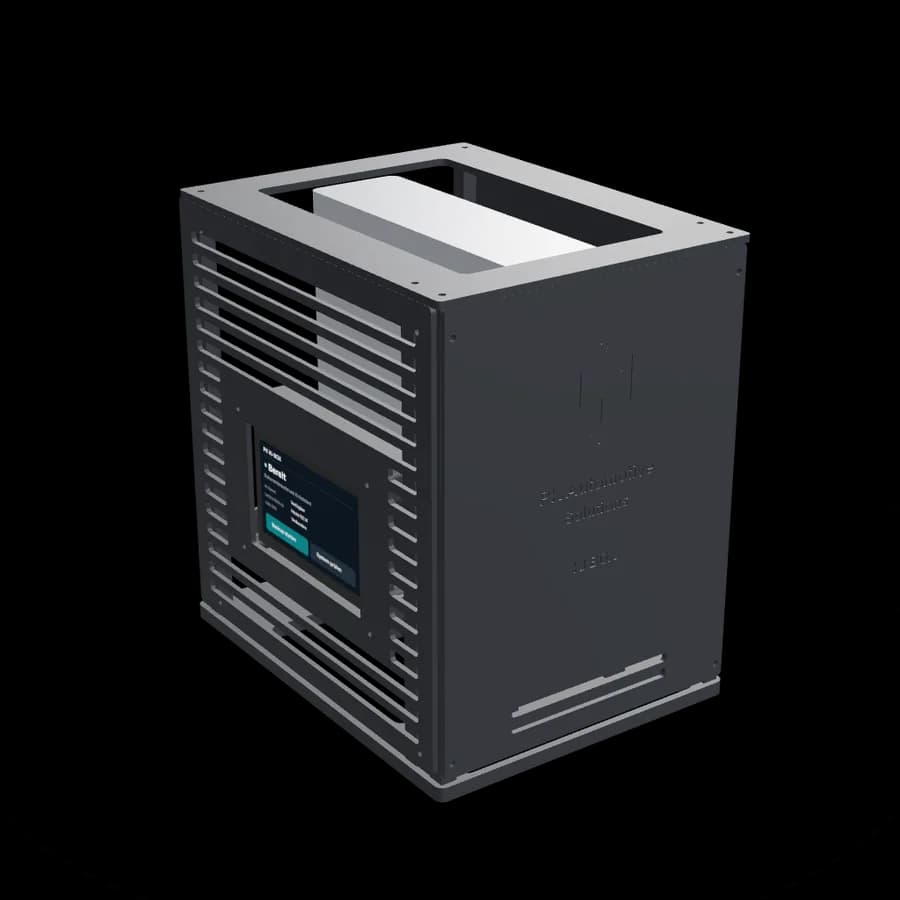 The PK KI-Box: a black enclosure with ventilation slots, a status display on the left side and the PK logo embossed on the front.