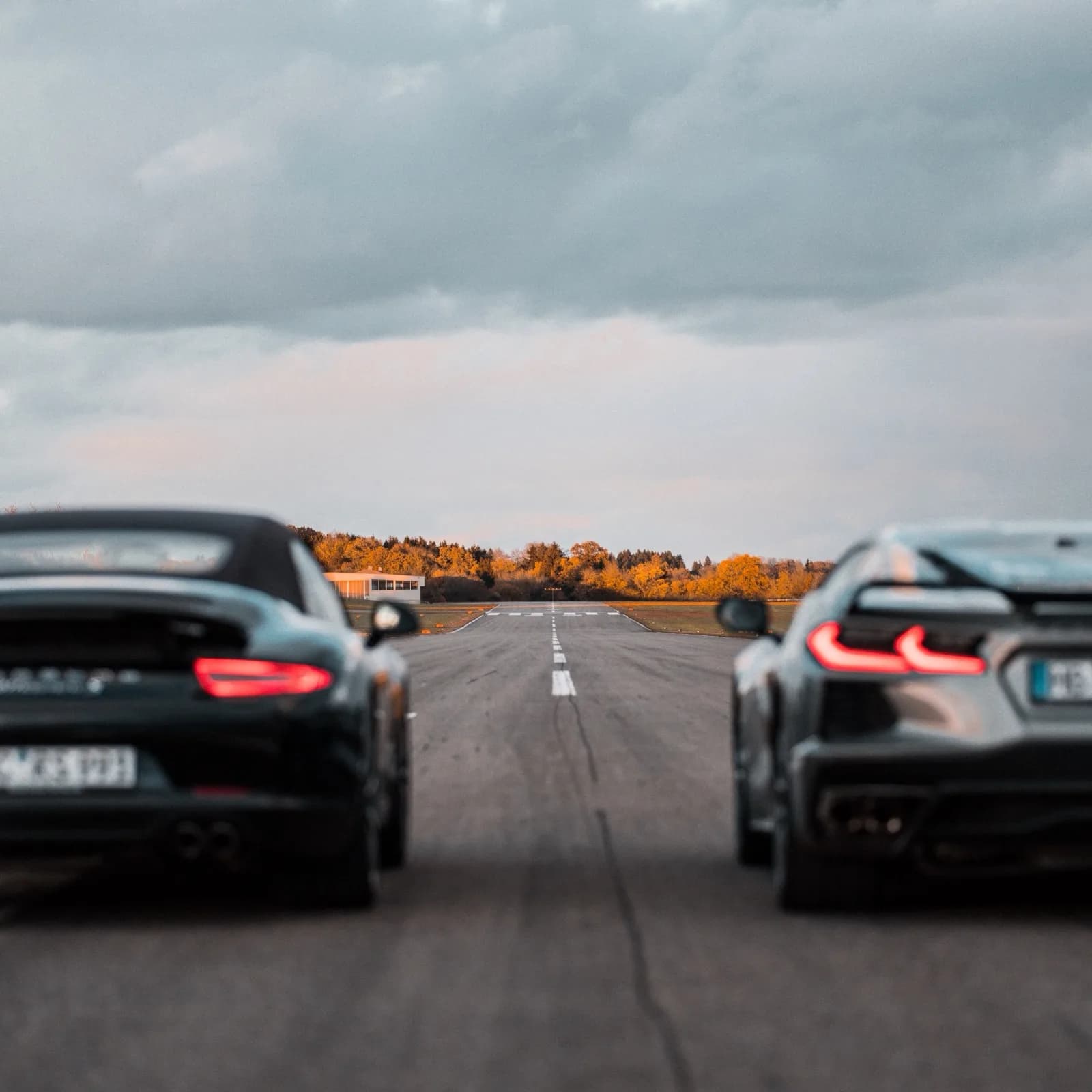 Corvette C8 and Porsche 911 from behind on the runway